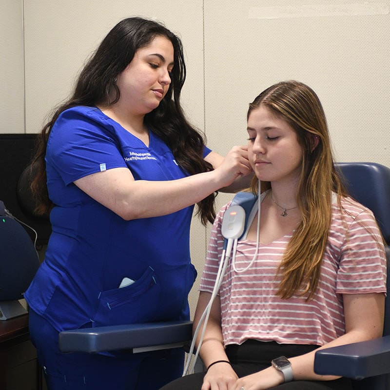 Ashley Rodrigues With A Patient at Duncan Hearing Healthcare