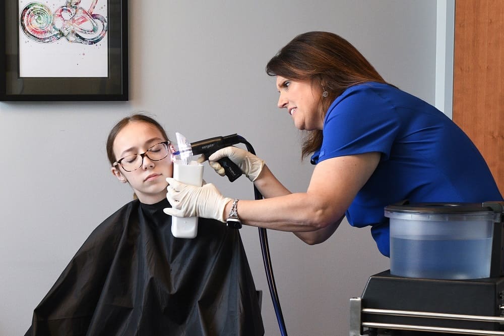 Earwac Removal Our Audiologist, Carrie, performing earwax removal