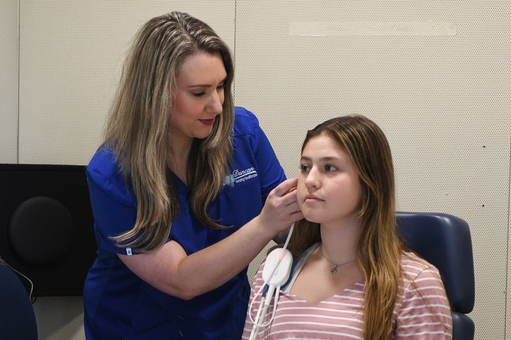 Hearing Aid Fitting An Audiologist performing a Hearing Aid Fitting